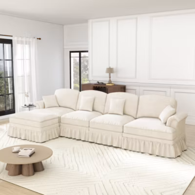 Canapé d&rsquo;angle 4 places modulable en chenille blanc avec pouf, jupe amovible et pieds fuselés